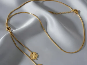 Carry a charm of good fortune with this elegant lariat necklace featuring a polished four-leaf clover pendant. Crafted with a radiant gold-tone chain, its adjustable design lets you wear it as a chic choker or a delicate Y-necklace. Perfect for everyday wear, this minimalist piece adds a subtle touch of luck and style, making it a meaningful gift or personal talisman. ROSAEL