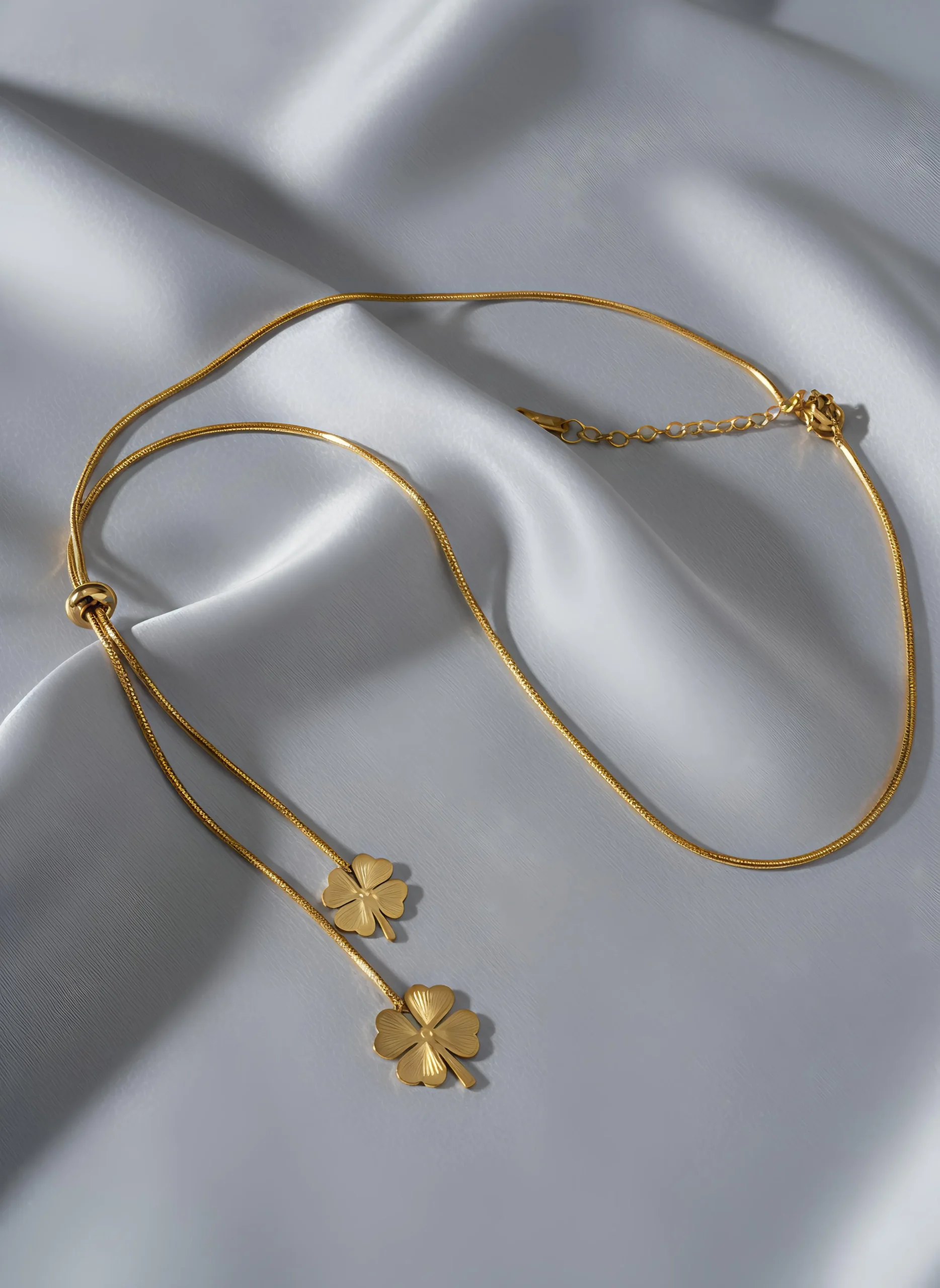 Carry a charm of good fortune with this elegant lariat necklace featuring a polished four-leaf clover pendant. Crafted with a radiant gold-tone chain, its adjustable design lets you wear it as a chic choker or a delicate Y-necklace. Perfect for everyday wear, this minimalist piece adds a subtle touch of luck and style, making it a meaningful gift or personal talisman. ROSAEL