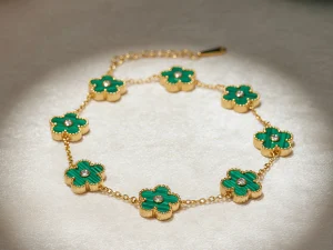 Carry the charm of a sunlit garden with this elegant bracelet featuring rich green clover charms set in polished gold. Playful and vibrant, each charm symbolizes renewal and luck. Adjustable for the perfect fit, this versatile piece shines alone or layered, making it a meaningful gift for growth and prosperity.