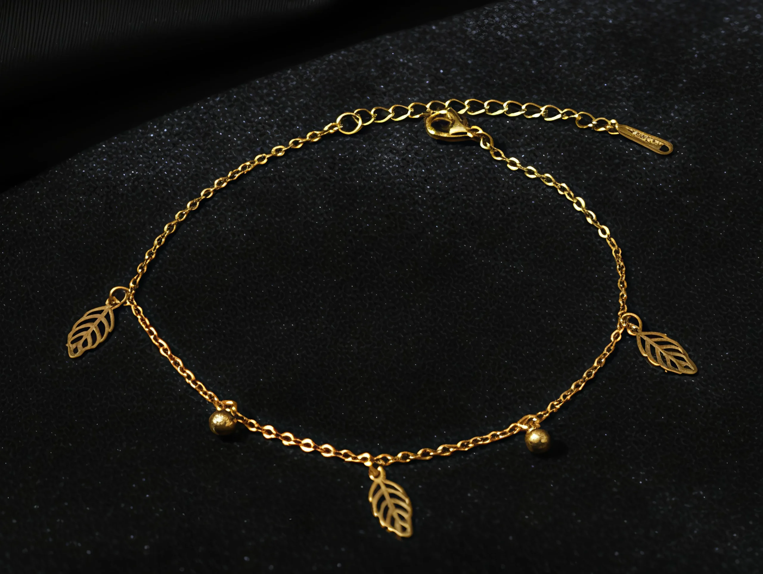 Celebrate nature’s elegance with this delicate gold chain adorned with intricate leaf charms and shimmering beads. Wear it as a dainty bracelet or a minimalist anklet for a subtle, botanical touch. Perfect for nature lovers, it’s a timeless piece that adds understated beauty to any look. ROSAEL