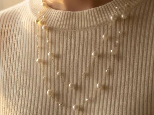 Timeless and elegant, the Lumina Pearl Strand features lustrous pearls spaced along a delicate chain. Wear it long or double it for a layered look—perfect for bridal wear, evening outfits, or everyday elegance. A classic pearl necklace gift for her to treasure.